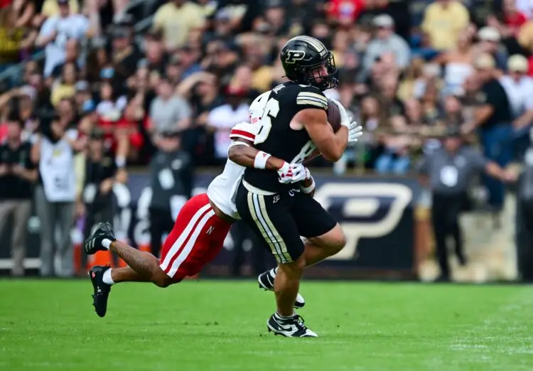 Sep 28, 2024; West Lafayette, Indiana, USA; Purdue Boilermakers tight end Max Klare (86) is tackled by Nebraska Cornhuskers defensive back Malcolm Hartzog Jr. (7) during the second half at Ross-Ade Stadium. Mandatory Credit: Marc Lebryk-Imagn Images