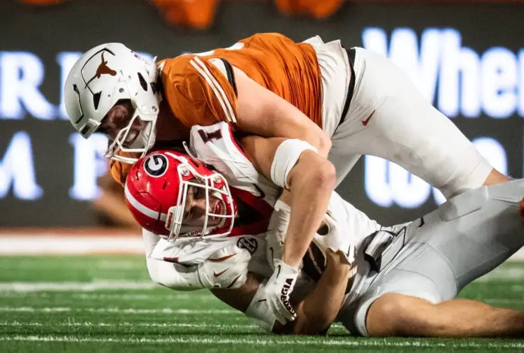 Oct 19, 2024; Austin, Texas, USA; Texas Longhorns linebacker Ethan Burke (91) tackles Georgia Bulldogs tight end Lawson Luckie (7) in the first half at Darrell K. Royal Texas Memorial Stadium. Mandatory Credit: Sara Diggins/USA TODAY Network via Imagn Images