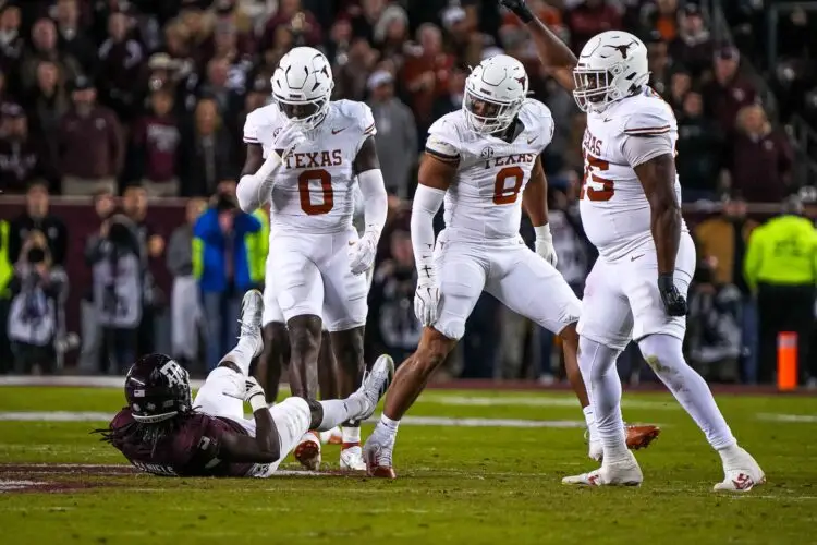 Nov 30, 2024; College Station, Texas, USA; Texas Longhorns linebacker Anthony Hill Jr. (0) looks down at Texas A&M running back Amari Daniels (5) after a tackle during the Lone Star Showdown at Kyle Field. Mandatory Credit: Sara Diggins/USA TODAY Network via Imagn Images