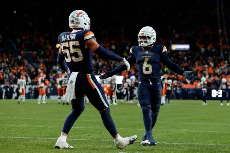Dec 2, 2024; Denver, Colorado, USA; Denver Broncos linebacker Cody Barton (55) celebrates his interception with safety P.J. Locke (6) in the fourth quarter against the Cleveland Browns at Empower Field at Mile High. Mandatory Credit: Isaiah J. Downing-Imagn Images