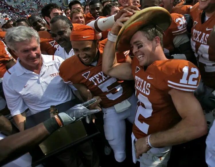 Texas head coach Mack Brown, left, looks on as Colt McCoy right, puts on the Golden Hat Trophy after the Longhorns defeated the Oklahoma Sooners 16-13 during the AT&T Red River Rivalry held at the Cotton Bowl in Dallas, Texas, on Saturday, October 17, 2009.Photo:Rodolfo Gonzalez/American-Statesman / USA TODAY NETWORK via Imagn Images
