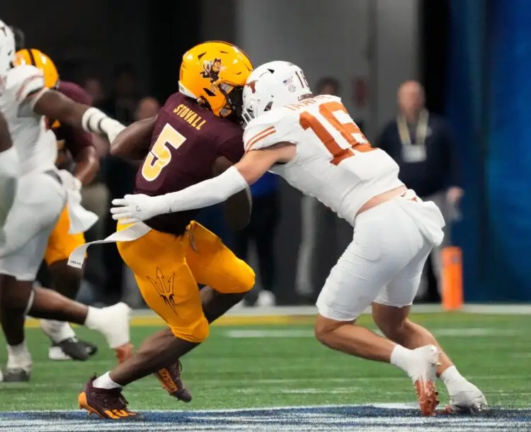 Arizona State wide receiver Melquan Stovall (5) is tackled by Texas defensive back Michael Taaffe (16) after a catch during the fourth quarter in the Chick-fil-A Peach Bowl in Atlanta on Wednesday, Jan. 1, 2025. Photo: Michael Chow/The Republic / USA TODAY NETWORK via Imagn Images