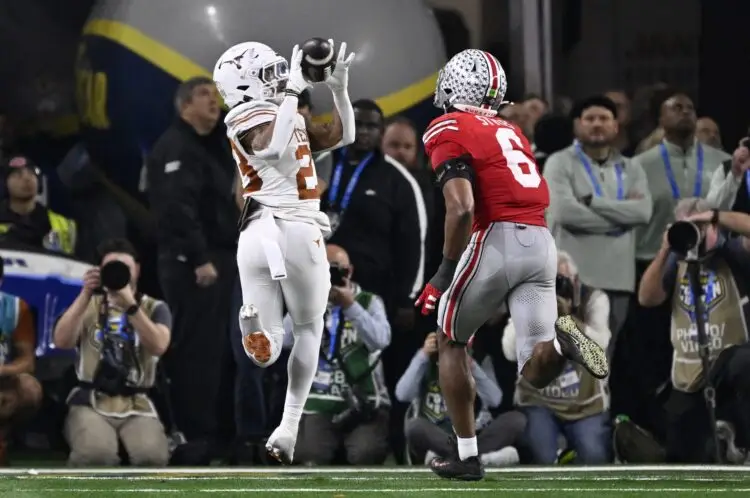 Jan 10, 2025; Arlington, Texas, USA; Texas Longhorns running back Jaydon Blue (23) catches a touchdown against Ohio State Buckeyes safety Sonny Styles (6) during the second quarter of the College Football Playoff semifinal in the Cotton Bowl at AT&T Stadium. Mandatory Credit: Jerome Miron-Imagn Images