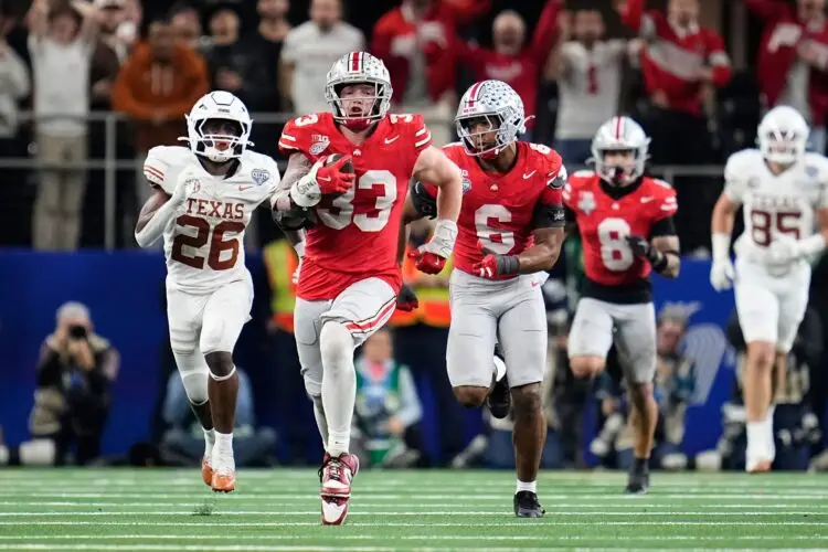 Ohio State Buckeyes defensive end Jack Sawyer (33) returns a fumble recovery for a touchdown after sacking Texas Longhorns quarterback Quinn Ewers (3) during the second half of the Cotton Bowl Classic College Football Playoff semifinal game at AT&T Stadium in Arlington, Texas on Jan. 10, 2025. Sawyer returned the fumble for a touchdown, and Ohio State won 28-14.