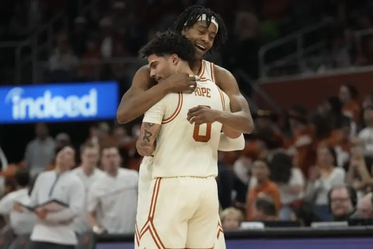 Jan 11, 2025; Austin, Texas, USA; Texas Longhorns guards Tre Johnson (20) and Jordan Pope (0) embrace after Pope scored a three point basket during the first half against the Tennessee Volunteers at Moody Center. Mandatory Credit: Scott Wachter-Imagn Images