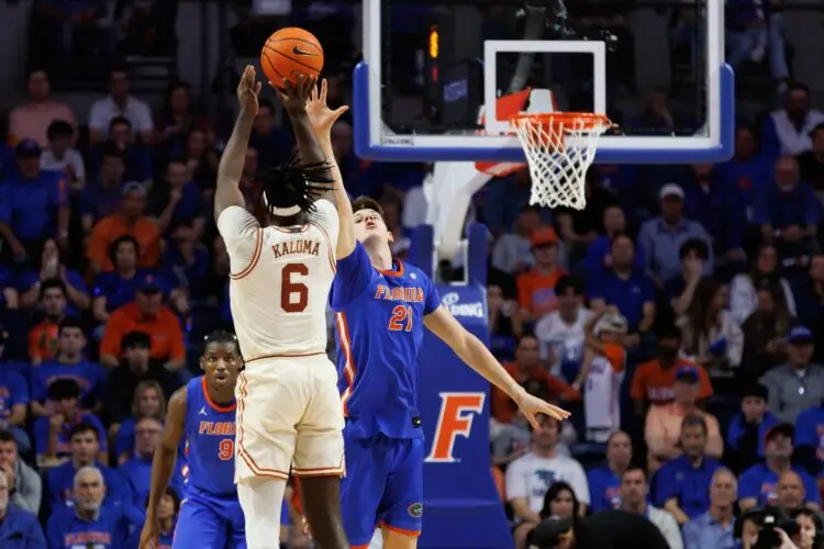 Jan 18, 2025; Gainesville, Florida, USA; Florida Gators forward Alex Condon (21) defends a three point basket from Texas Longhorns forward Arthur Kaluma (6) during the second half at Exactech Arena at the Stephen C. O'Connell Center. Mandatory Credit: Matt Pendleton-Imagn Images