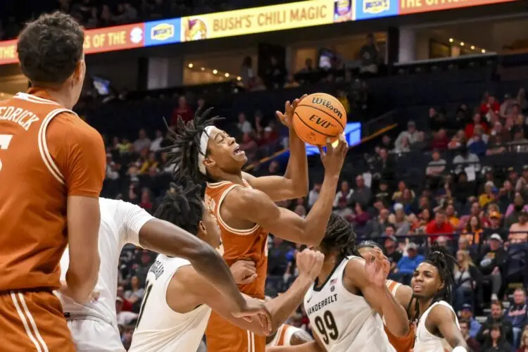 Mar 12, 2025; Nashville, TN, USA; Texas Longhorns guard Tre Johnson (20) shoots over Vanderbilt Commodores guard AJ Hoggard (11) during the second half at Bridgestone Arena. Mandatory Credit: Steve Roberts-Imagn Images