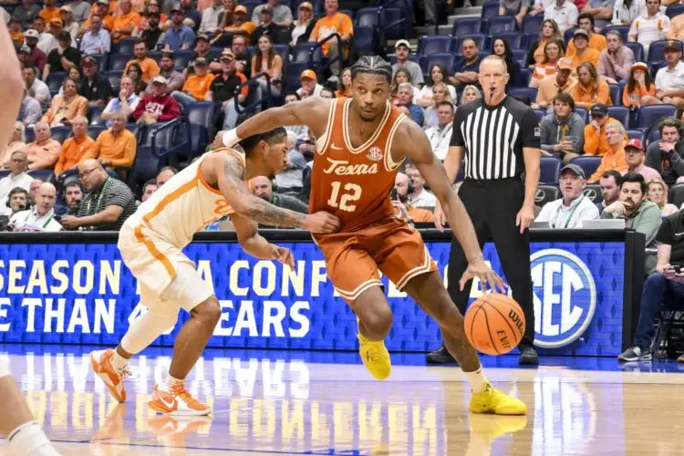 Mar 14, 2025; Nashville, TN, USA;  Texas Longhorns guard Tramon Mark (12) drives to the basket past Tennessee Volunteers guard Chaz Lanier (2) during the second half at Bridgestone Arena. Mandatory Credit: Steve Roberts-Imagn Images