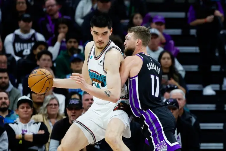 Mar 17, 2025; Sacramento, California, USA; Memphis Grizzlies center Zach Edey (14) controls the ball against Sacramento Kings forward Domantas Sabonis (11) during the second quarter at Golden 1 Center. Mandatory Credit: Sergio Estrada-Imagn Images