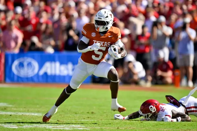 Oct 11, 2025; Dallas, Texas, USA; Texas Longhorns running back Quintrevion Wisner (5) runs with the ball against the Oklahoma Sooners during the first half at the Cotton Bowl. Mandatory Credit: Jerome Miron-Imagn Images